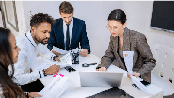 animate presentation ppt Photograph of 4 people in an office using a laptop to make a company presentation