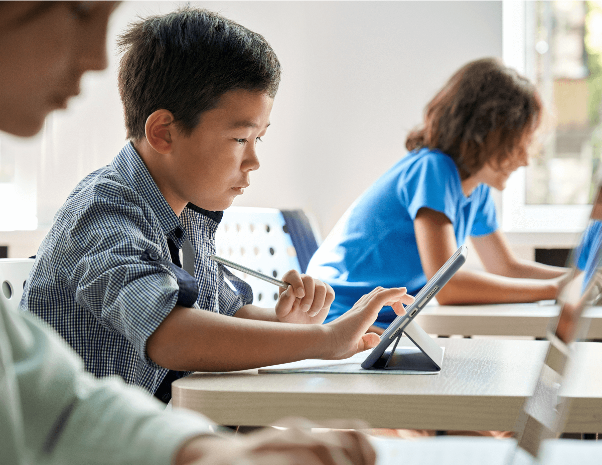 Kids in a classroom with tablets