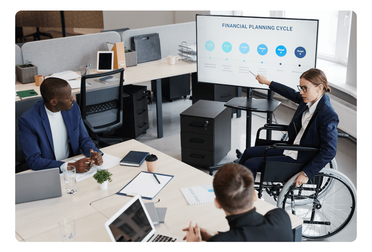 Three people, one of them in a wheelchair, giving a pitch presentation